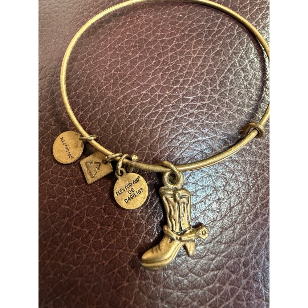Alex and Ani Cowboy Boot charm bracelet featuring a gold-toned expandable bangle